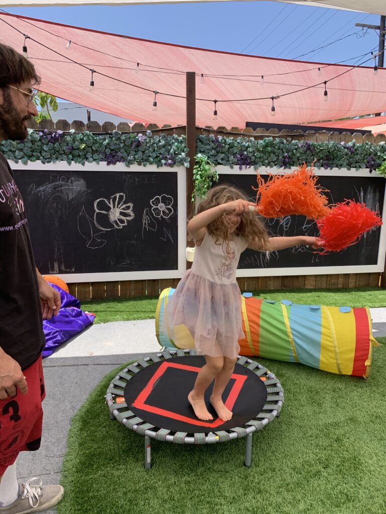 Young girl jumping on a trampoline.