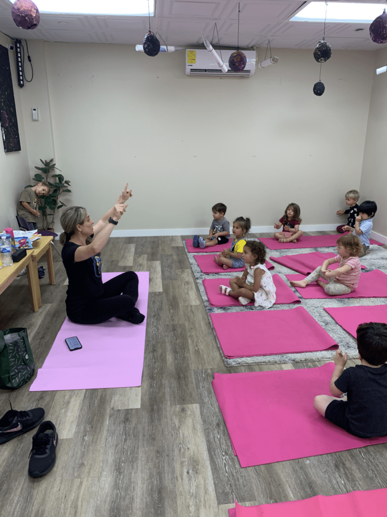 Children's yoga class with instructor.