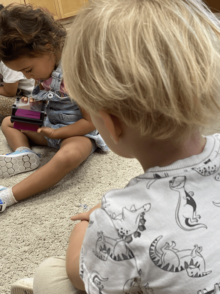 Two children playing with a toy.