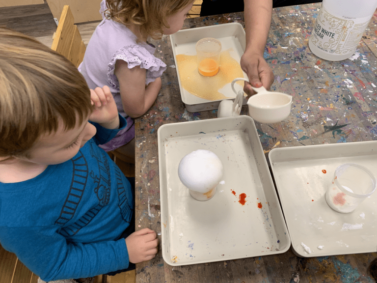 Kids watching a science experiment.